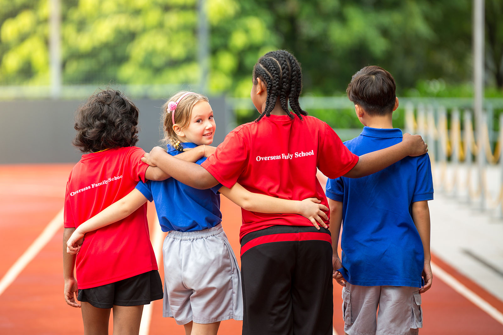 Four OFS Elementary School students standing in the track field