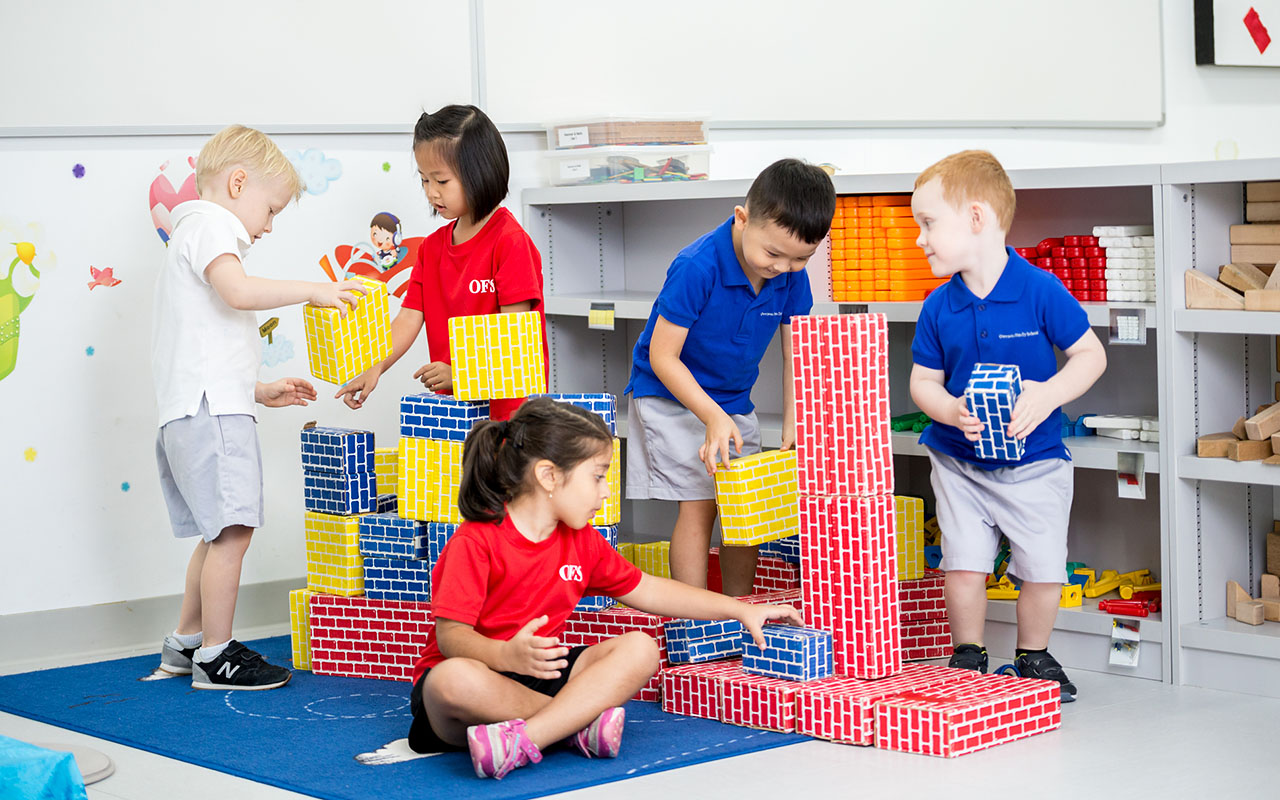 OFS Kindergarten students playing with colorful blocks in the classroom