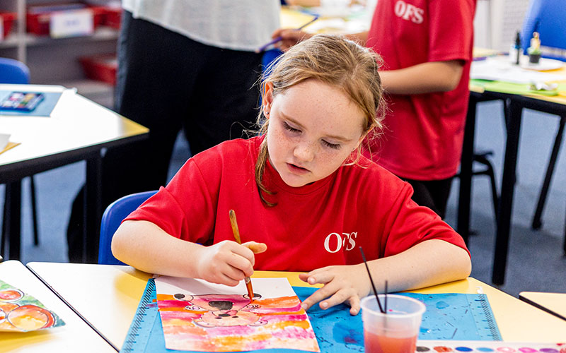 OFS Elementary School student drawing during art class