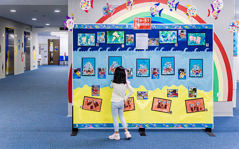 OFS Kindergarten student watching art exhibition