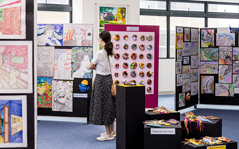 OFS Middle School parent watching art exhibition