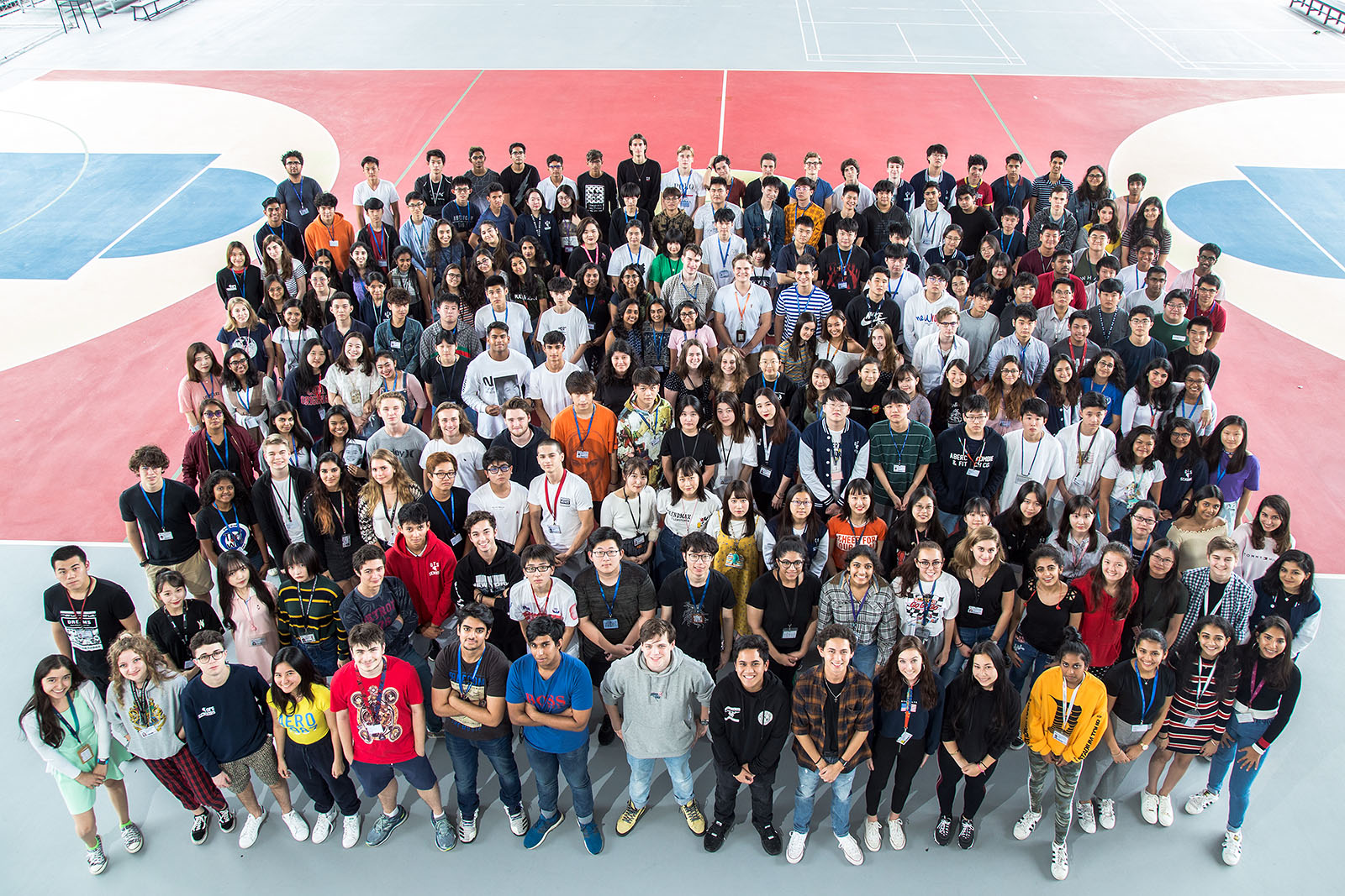 OFS Senior High School students posing for the camera on their last day of school before graduation on the basketball court