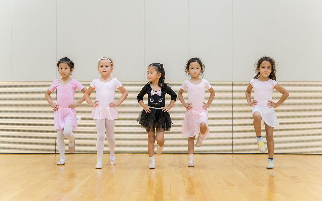 Five female OFS Elementary School students posing during ballet enrichment class in the dance studio