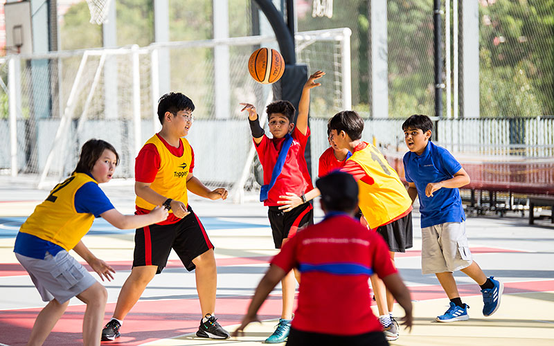 OFS Elementary School students playing football against another
