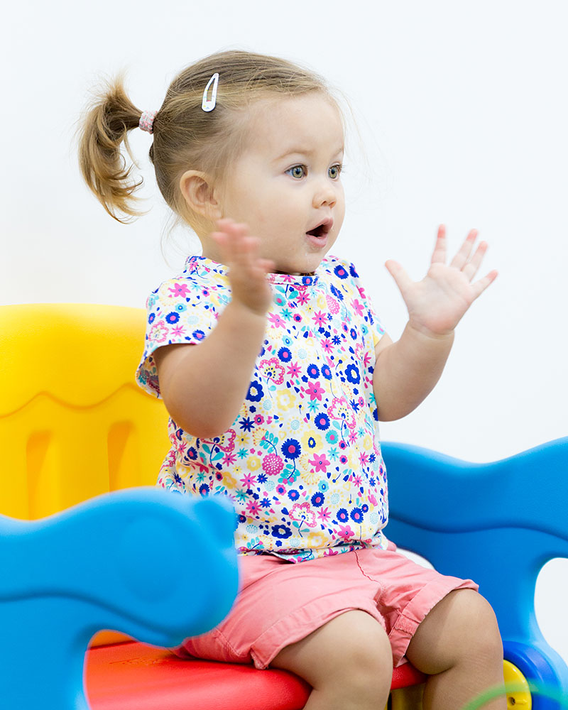 A female toddler clapping her hands during OFS Playgroup session