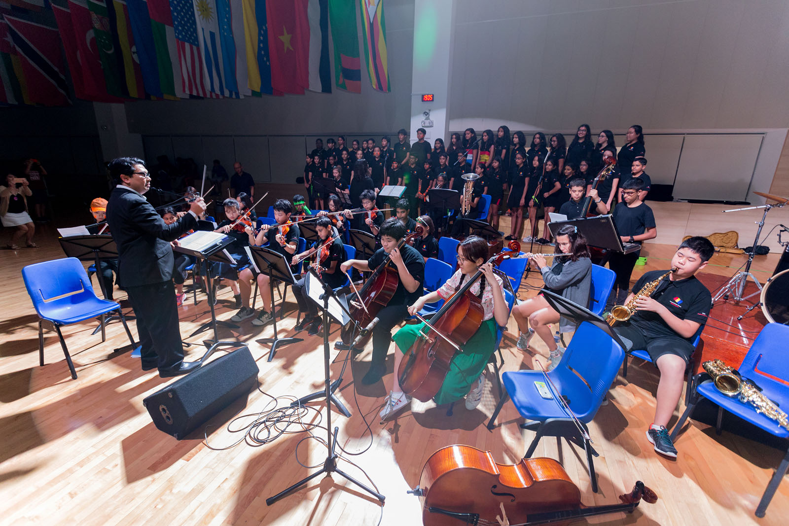 OFS Middle School Performing Arts students playing instruments in auditorium during Middle School Graduation
