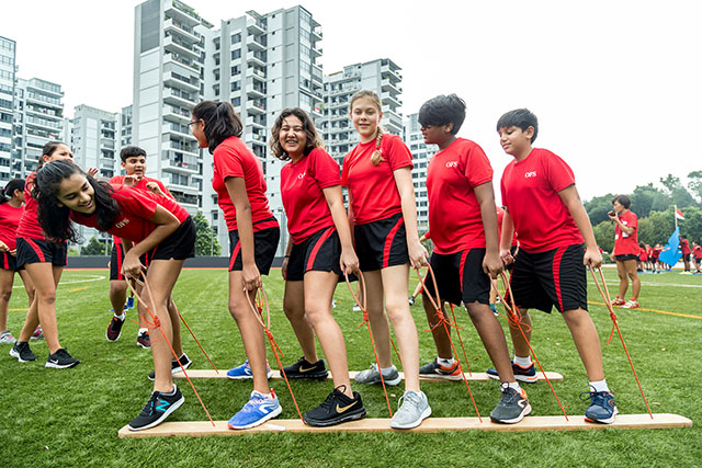 OFS Middle School students competing in sports on the football field