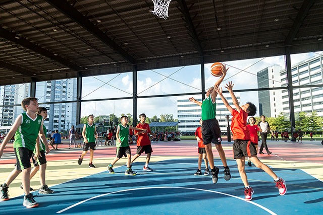 OFS Elementary School boys basketball team playing on the court