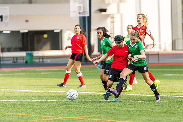 OFS High School girls football team playing on the field