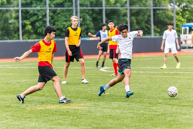 OFS High School boys football team playing on the field