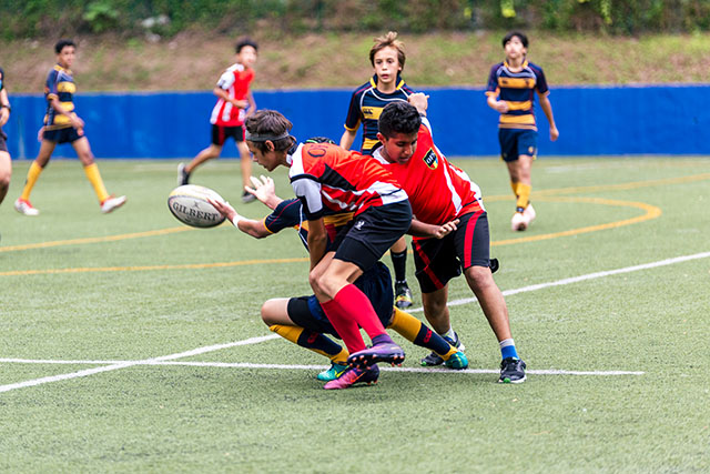 OFS High School boys rugby team playing on the field