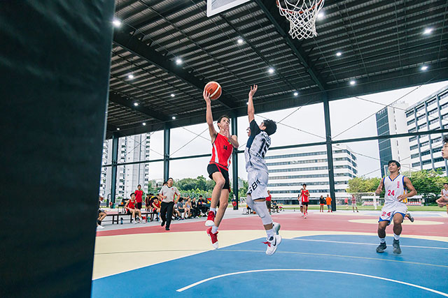 OFS High School boys basketball team playing on the court