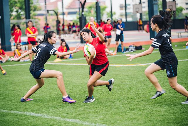 OFS High School girls touch rugby team playing on the field