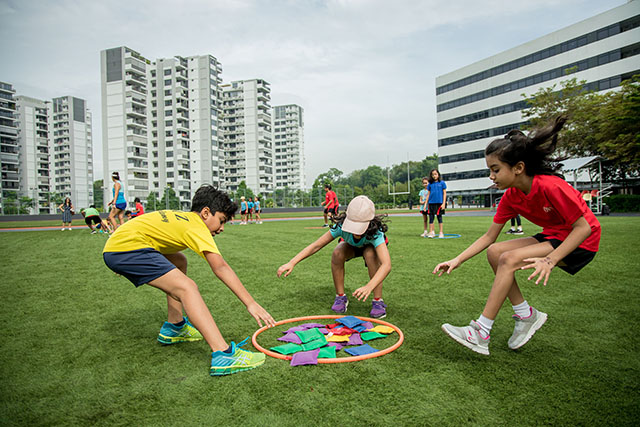 OFS Elementary School students competing in sports on the football field