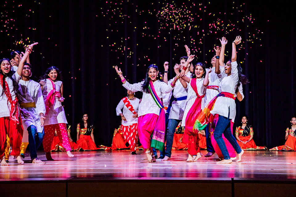 OFS High School students performing Indian modern dance on the auditorium stage