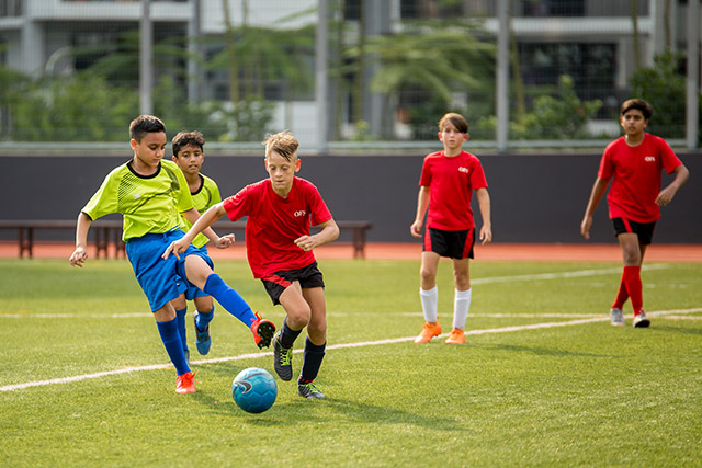 OFS Middle School boys football team playing on the field