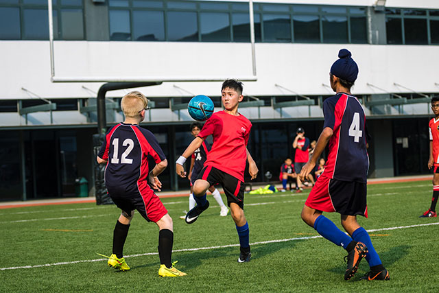 OFS Elementary School boys football team playing on the field