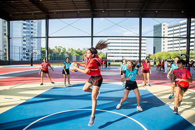 OFS High School girls netball team playing on the court