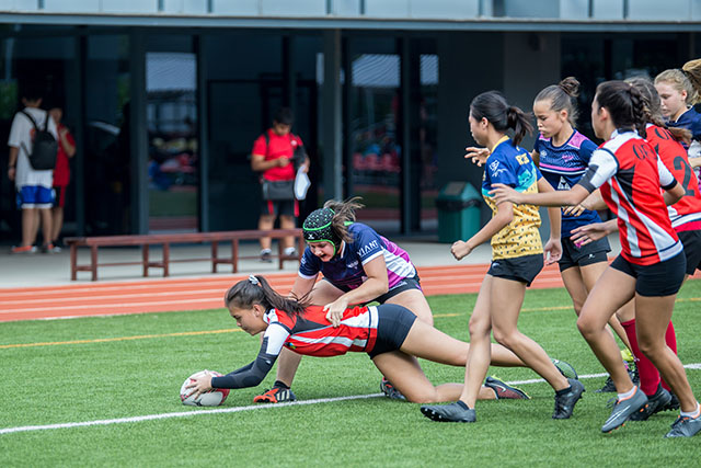 OFS High School girls rugby team playing on the field