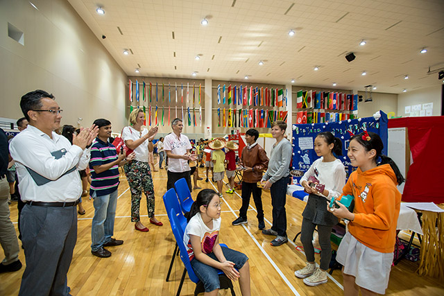 OFS Elementary School Grade 5 students giving presentation to parents in auditorium