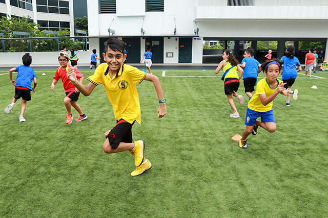 OFS Elementary School students competing on the football field during sports morning
