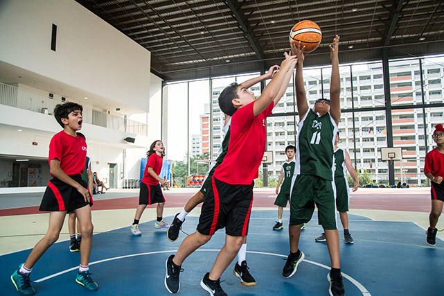 OFS Elementary School boys football team playing against UWC East on the field