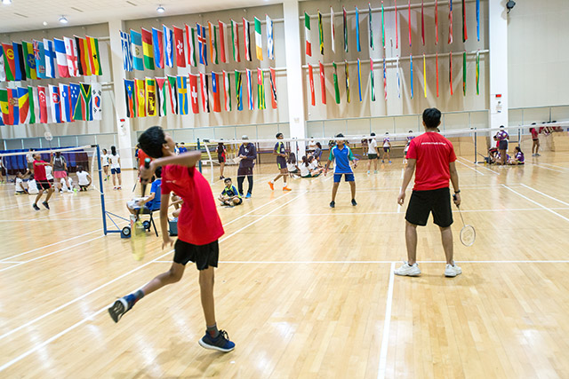 OFS Middle School students playing badminton against other schools