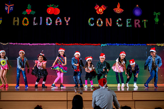 OFS Elementary School students performing on the auditorium stage during Holiday Concerts 2019