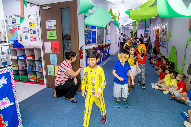 OFS Kindergarten students parading in their animal costumes along the school hallways