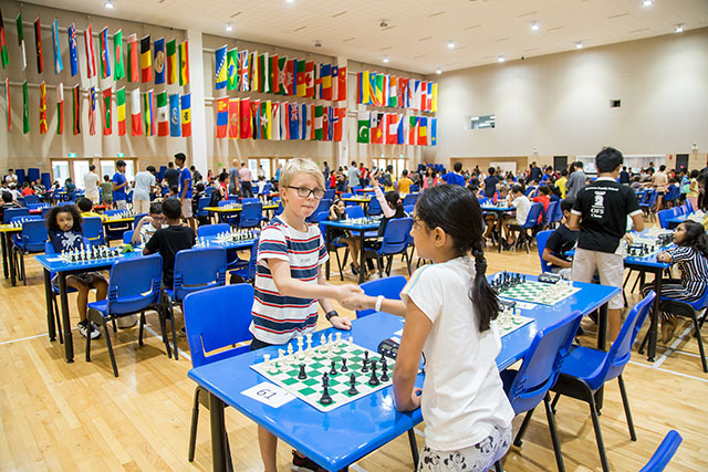 Two OFS Elementary School students shaking hands after a chess match